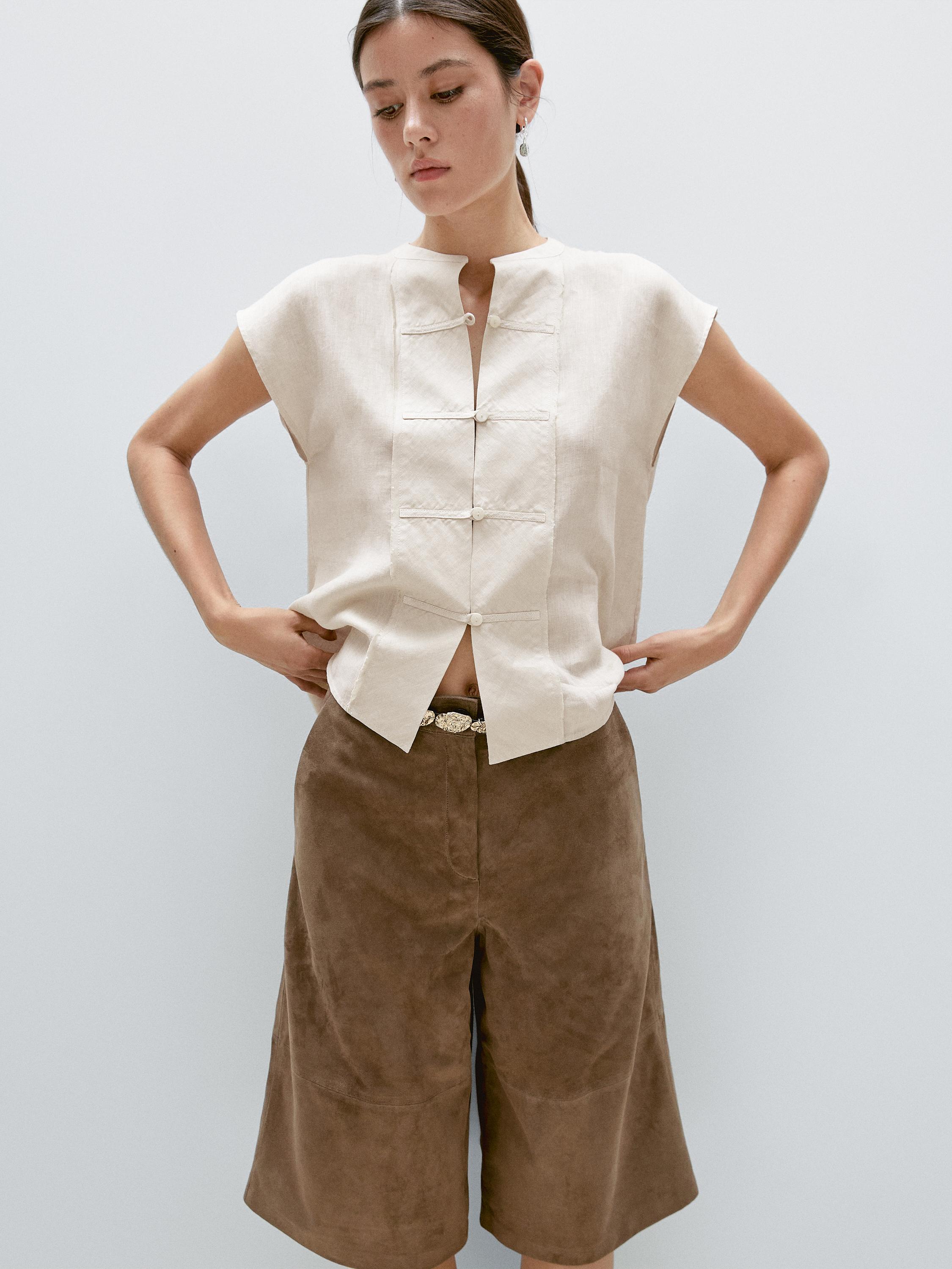 Veste sans manches plastron boutonné